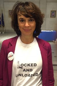 Leah Gunn Barrett brandishes the"Locked and Unloaded" message in Albany.