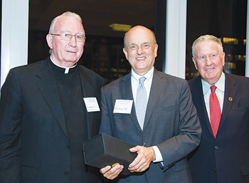 Joseph A. O’Hare, S.J., left, received the George J. Mitchell Lifetime Public Service Award on Sept. 24; pictured with Dean Michael M. Martin, center, and John D. Feerick. Photo by Ben Asen