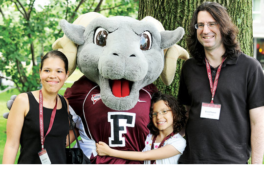 David Thomer, FCRH ’97, greets Ramses the Mascot with daughter Alexandra, 10, and wife Patricia Gillett, FCRH ’98, at Jubilee 2012 Photo by Chris Taggart