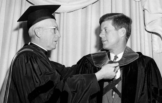 Laurence J. McGinley, S.J., left, presents Fordham’s honorary Doctor of Laws to Sen. John F. Kennedy of Massachusetts. Kennedy addressed the Fordham Law Alumni Association’s annual luncheon, commenting that he was honored to become an alumnus of an institution that has “never maintained its neutrality in moments of great moral crisis.”