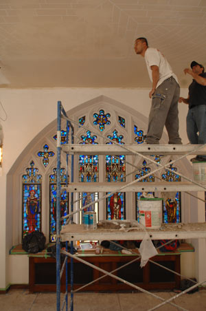 Keating Blue Chapel (above) was a source of great pride for the University when it was built in the 1930s, prominently featured in the alumni magazine. Earlier this year, workers (below) began restoring the chapel to its original specifications, including a faux brick ceiling. Today, the chapel (bottom) looks much the way it did in the 1930s, with faux stone walls and the original hand-hammered steel altarpiece.