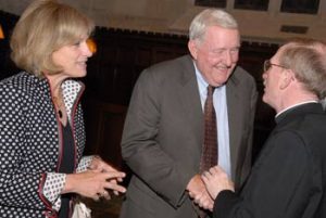 Joseph M. McShane, S.J., president of Fordham, greets E. Gerald Corrigan and his wife, Cathy E. Minehan, during a celebration in Corrigan’s honor. Photo by Chris Taggart