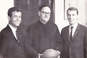 George McMahon, SJ, then dean of Fordham College, stands with Langdon (right) and student government president Donald Ross.