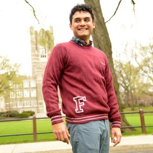 A sweater made by domestic abuse survivors in Bolivia is modeled by economics PhD candidate Walter Bazan. 