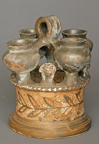 Kernos (vase for multiple offerings with mold made figural protomes), Greek, South Italian, Campanian, Late Classical, ca. late 4th century B.C.E. Terracotta, h: 6¼ in. (15.9 cm), from the Fordham Museum of Greek, Etruscan, and Roman Art