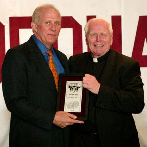 Frank McLaughlin give Father Currie the Jack Coffey Award