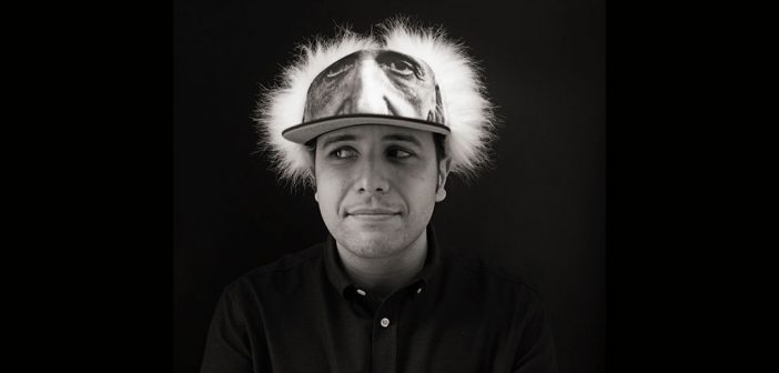 Fordham alumnus Anthony Iliakostas wearing what he likes to call his "thinking cap," an Albert Einstein wig hat