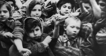 This image of child Holocaust survivors, including 4-year-old Michael Bornstein (in front on the right), is from film footage taken by Soviet soldiers days after they liberated Auschwitz on January 27, 1945. Courtesy of Pańtswowe Muzeum Auschwitz-Birkenau