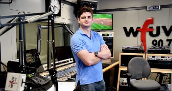 Fordham senior John Furlong stands in a studio at WFUV, where he has worked as a sports reporter and producer, gaining experience alongside pros in New York media.