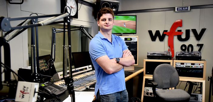 Fordham senior John Furlong stands in a studio at WFUV, where he has worked as a sports reporter and producer, gaining experience alongside pros in New York media.