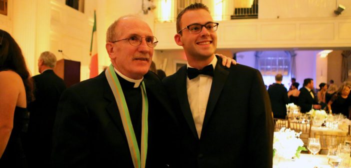 Father McShane with award medal