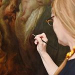 Restoring a 17th-Century Mexican Masterpiece: Met conservator Dorothy Mahon works on "The Adoration of the Magi," carefully correcting some discolored patches after having spent nearly 10 months preparing Villalpando’s 1683 painting for the exhibition that opened last July and closed in mid-October. (Photo by Dana Maxson)