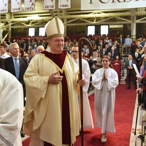 Cardinal Joseph W. Tobin, C.Ss.R., received an honorary doctorate of ministry at the Baccalaureate Mass on May 18. He's walking with a staff.