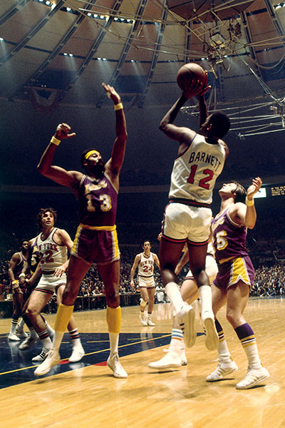 New York Knicks guard Dick Barnett goes up for a jump shot against the Los Angeles Lakers' Wilt Chamberlain in a 1972 game at Madison Square Garden.