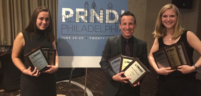 George Bodarky and two WFUV student journalists hold up award plaques they received at the Public Radio News Directors Incorporated awards ceremony