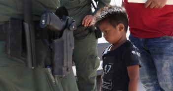 A boy and father from Honduras being taken into custody by United States Border Patrol agents near the Mexico border