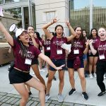 Student volunteers celebrate the arrival of first year students on 62nd street at the Lincoln Center campus.