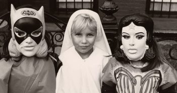 Three girls dressed up as Batgirl, St. Ann, and Wonder Woman for Halloween in 1970s Brooklyn