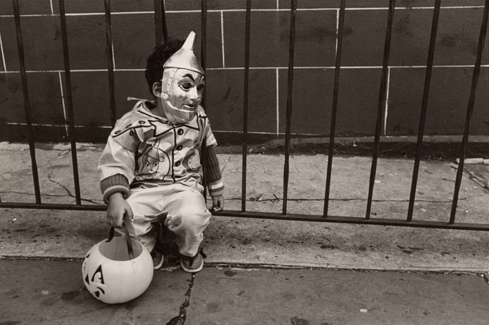A young boy dressed up for Halloween in a Tin Man costume