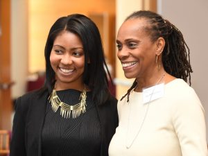 A student and Anne Williams-Isom, FCLC '86, CEO of Harlem Children's Zone, pose for a photo together