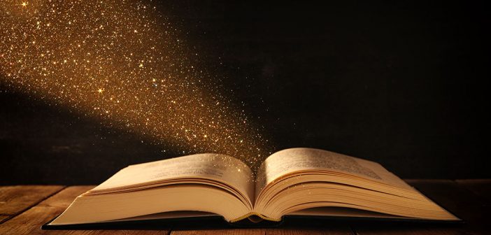 an open book with sparkly dust coming out of it