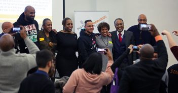 Leaders from South Bronx nonprofits with Professor Mark Chapman at a Martin Luther King Jr Day event at Rose Hill, posing for photos