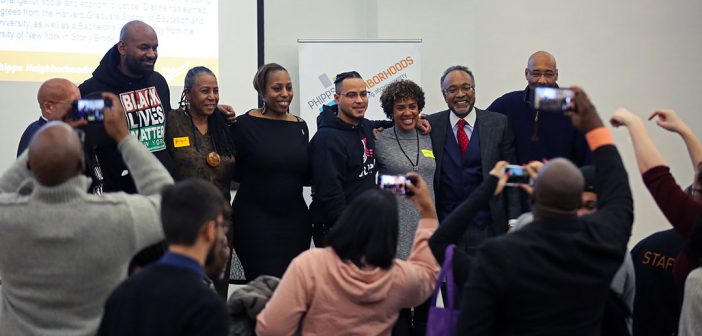 Leaders from South Bronx nonprofits with Professor Mark Chapman at a Martin Luther King Jr Day event at Rose Hill, posing for photos