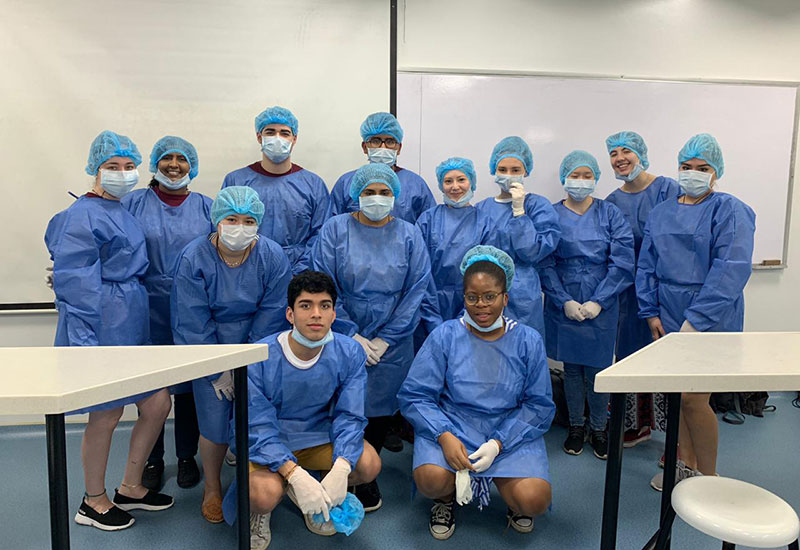 Fordham pre-health students in scrubs in a Cali, Colombia, health care setting