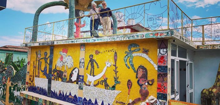A couple of alumni atop the Fusterlandia public art installation in Havana, Cuba