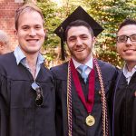 Three men in academic robes, with one wearing a medal.