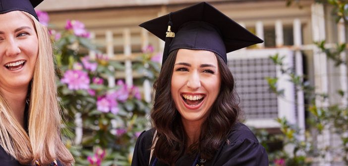 Close up of woman wearing a black academic cap laughing