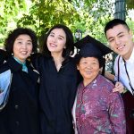 Graduate posing with four family members