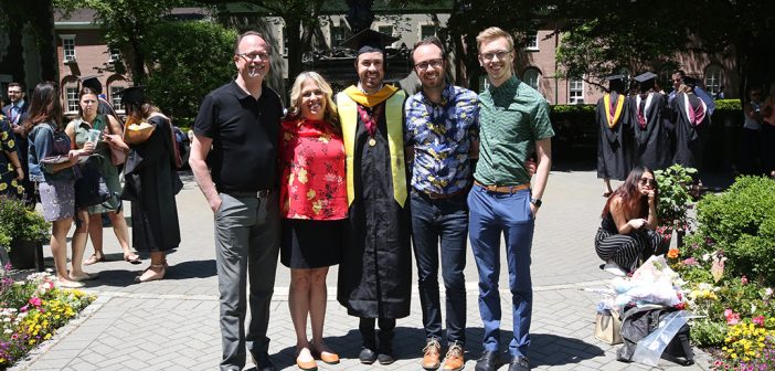 A family poses for a picture with a graduate