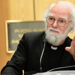 Rowan Williams gestures from the podium