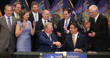 Al Gore shakes Andrew Cuomo's hand during a signing ceremony at Fordham Law School