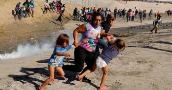 aria Meza (C), a 40-year-old migrant woman from Honduras, part of a caravan of thousands from Central America trying to reach the United States, runs away from tear gas with her five-year-old twin daughters Saira Mejia Meza (L) and Cheili Mejia Meza (R) in front of the border wall between the U.S. and Mexico, in Tijuana, Mexico, November 25, 2018.