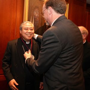 Archbishop Bernardito Auza receives the President's Medal from Provost Dennis Jacobs, Ph.D. 