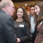 Father McShane chats with accepted students.