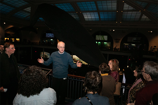 Robert J. Reilly and the group in the Milstein Family Hall of Ocean Life.