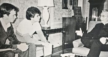 A black-and-white 1984 photo shows two Fordham student journalists, John Breunig and Dan Vincelette, interviewing Joseph A. O'Hare, S.J., then the new president of Fordham, in the president's office at Rose Hill.
