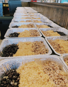 Platters filled with chicken, beans, and rice