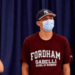 Student in Gabelli School t-shirt and face mask