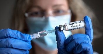 A doctor preparing to inject the COVID-19 vaccine
