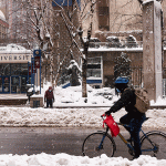 Bicycle going by snowy entrance to Fordham's Lincoln Center campus