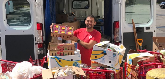 Jon Stepanian, FCLC ’06, loading a van with groceries to be distributed.