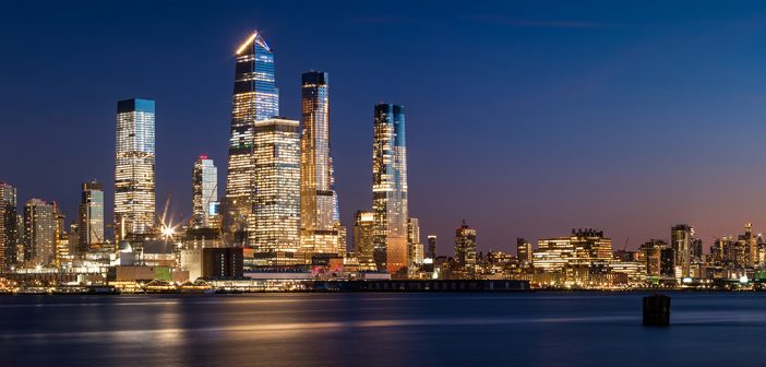 Manhattan West skyline at sunset with Hudson Yards skyscrapers and West Village buildings. Cityscape from across Hudson River, New York City, NY, USA