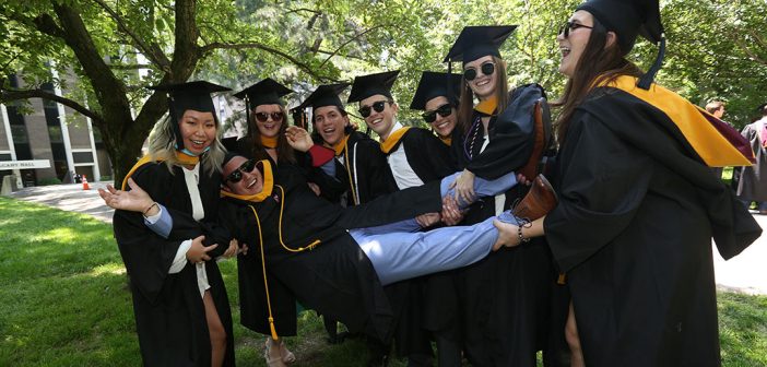 graduates carrying another grad
