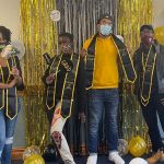 Students posing with balloons at Black graduation celebration