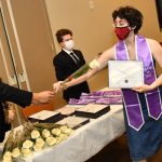 Student receiving white rose at LGBTQ Lavender Graduation