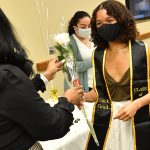 Studnet receiving rose at Black graduation celebration